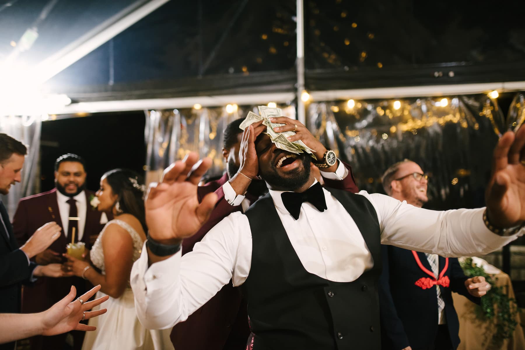 Groom does money dance at multicultural Cavallo Point wedding reception.