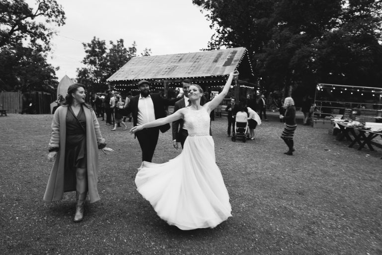 Black and white image of bridge dancing with barn in background at Reinstein Ranch in Livermore