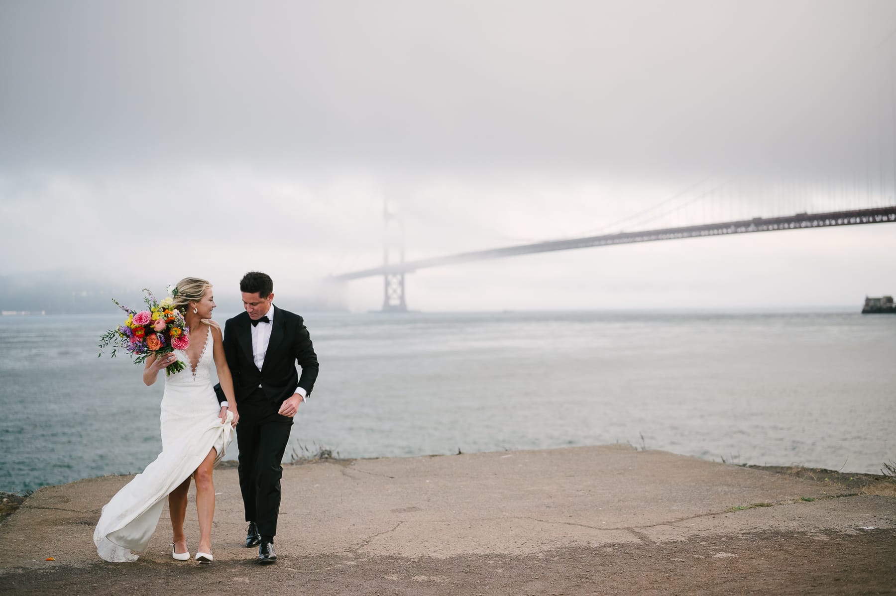 Couple portraits with views of the Golden Gate Bridge at Battery Yates near Travis Marina at Presidio Yacht Club wedding.